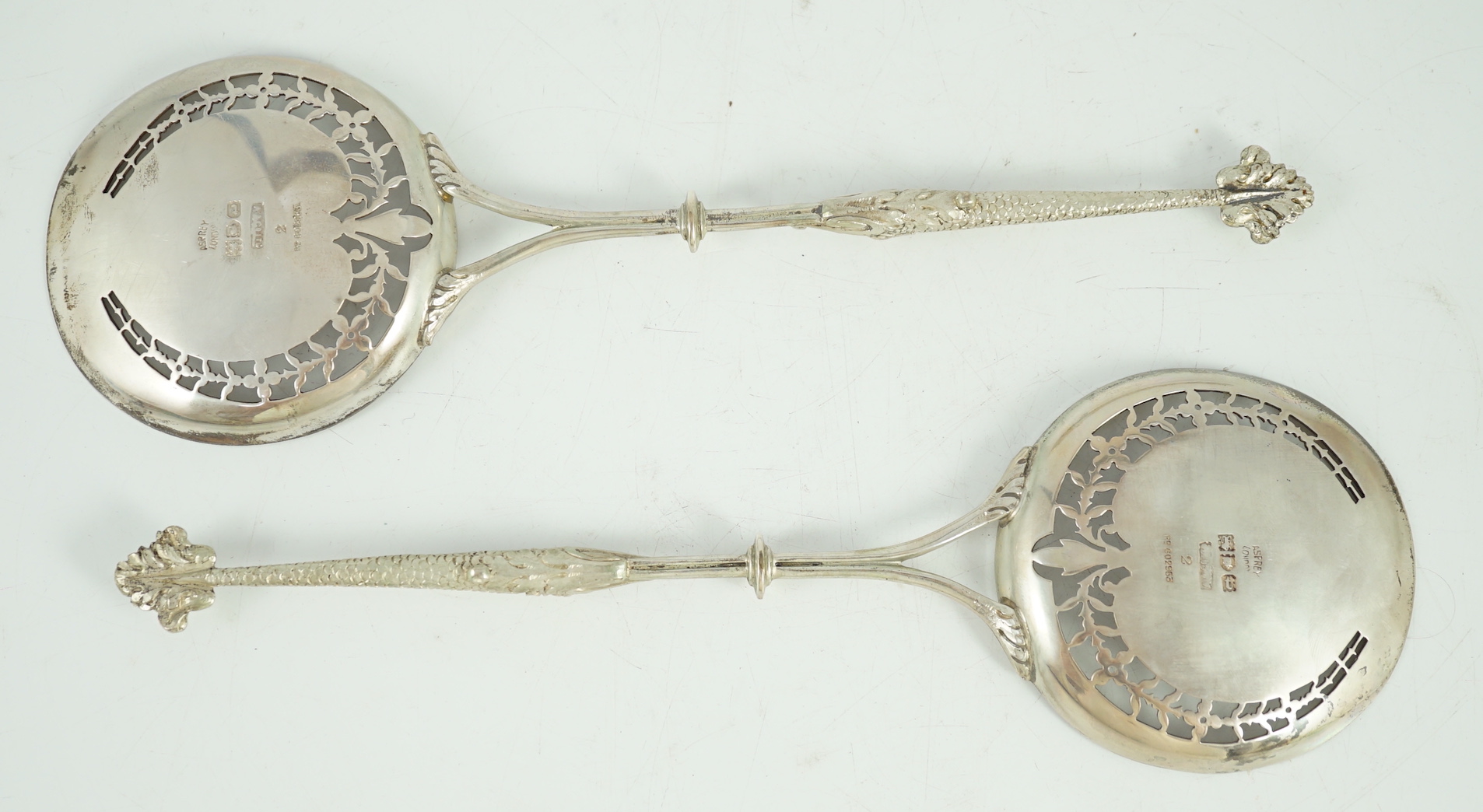 A pair of George V Asprey & Co pierced silver serving spoons